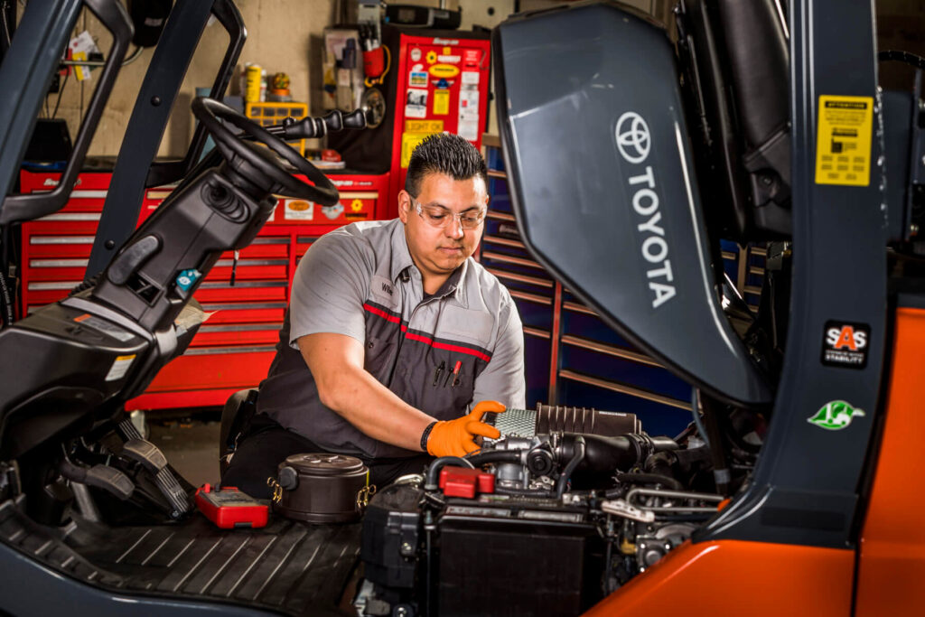 Technician installing Toyota forklift parts